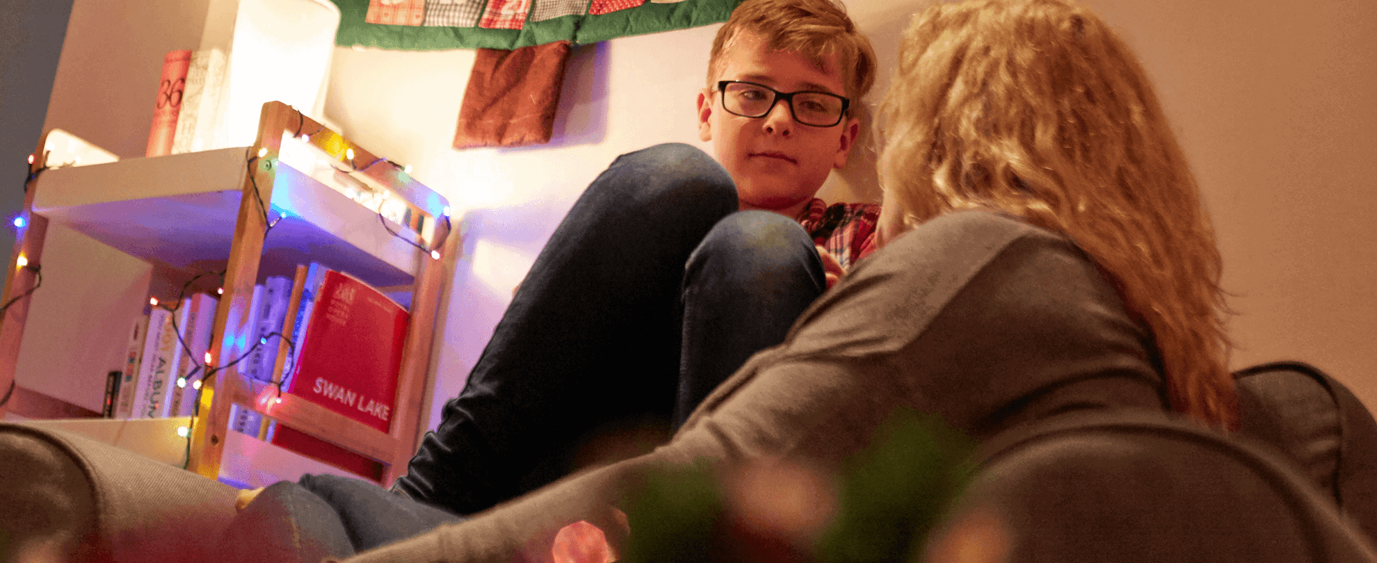 A mother in deep conversation with her young son in the lounge