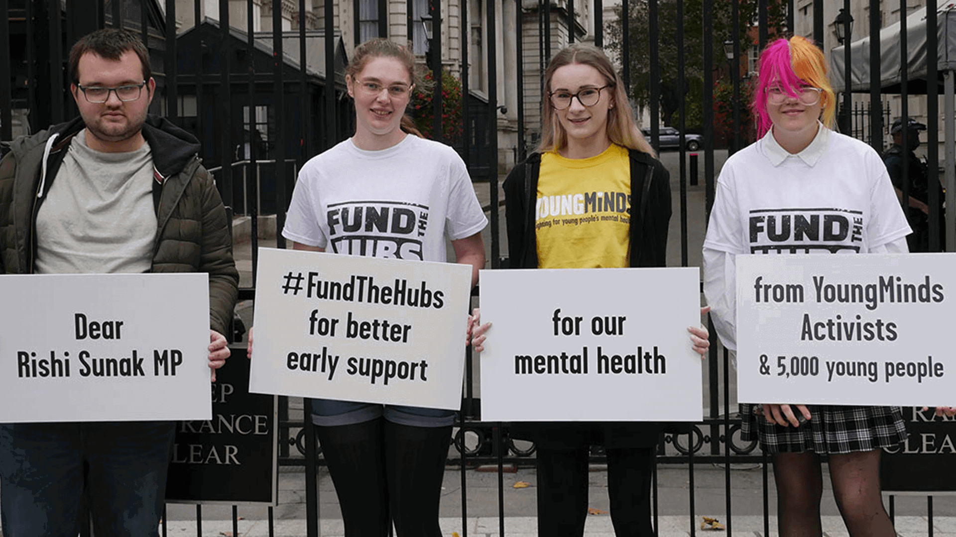 Four YoungMinds Activists at Downing Street holding placards calling for Rishi Sunak MP to Fund The Hubs