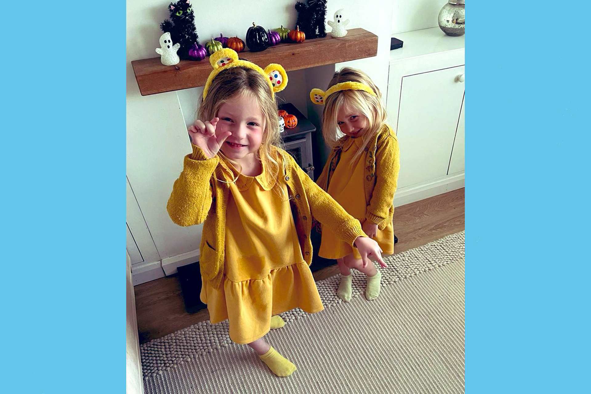 Two children from Brooklands Primary School dressed all in yellow with yellow bear ears.