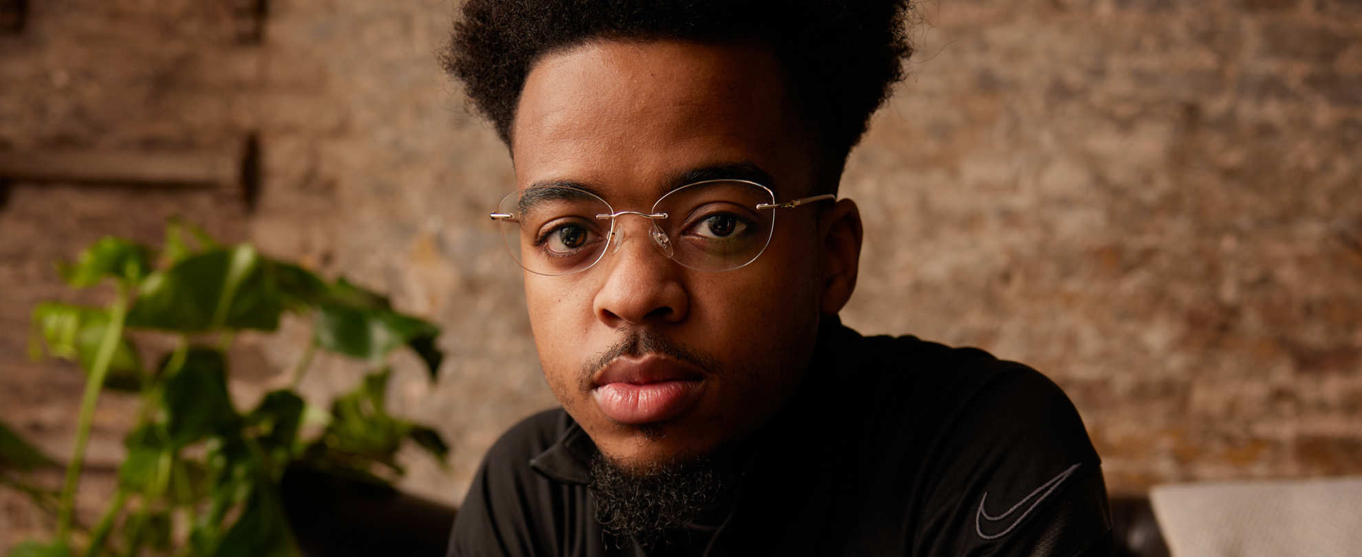 A young person looking directly at the camera.