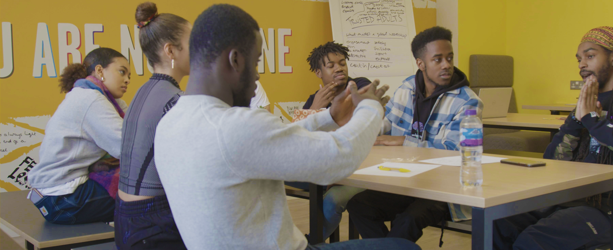 A group of young people discussing their poem ideas in the workshop.