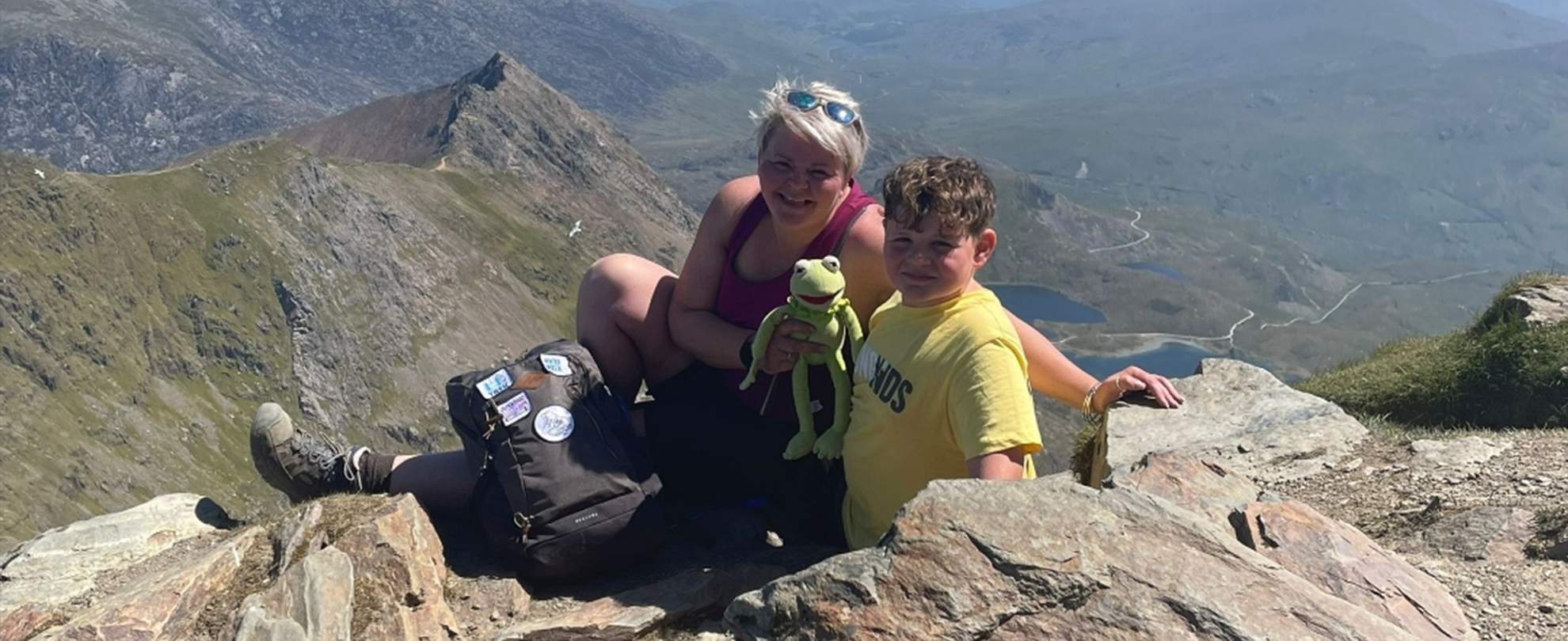 Flynn and his mum on the Snowdon mountain with a Kermit the frog toy.