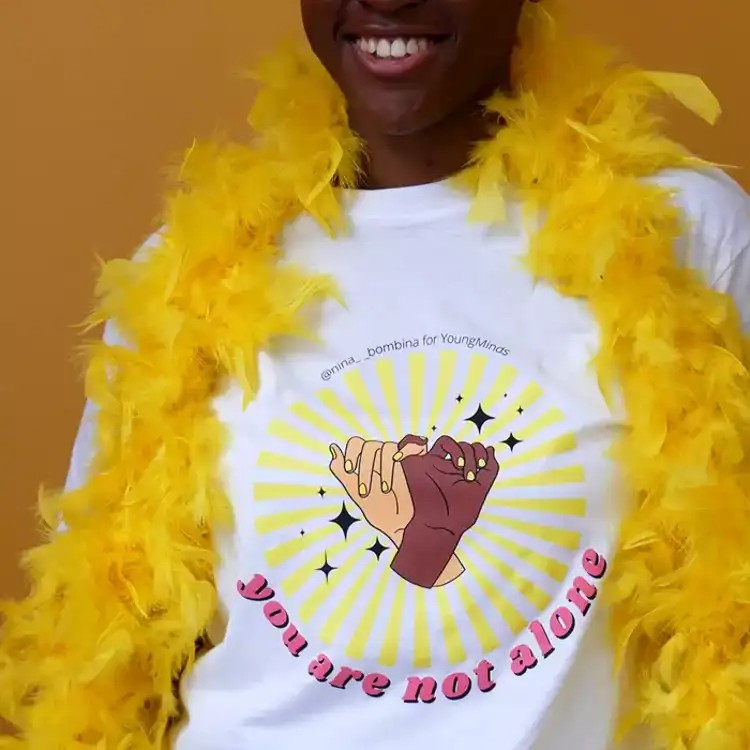 a close up of a Nina Bombina bespoke 'You are not alone' graphic Hello Yellow T-shirt