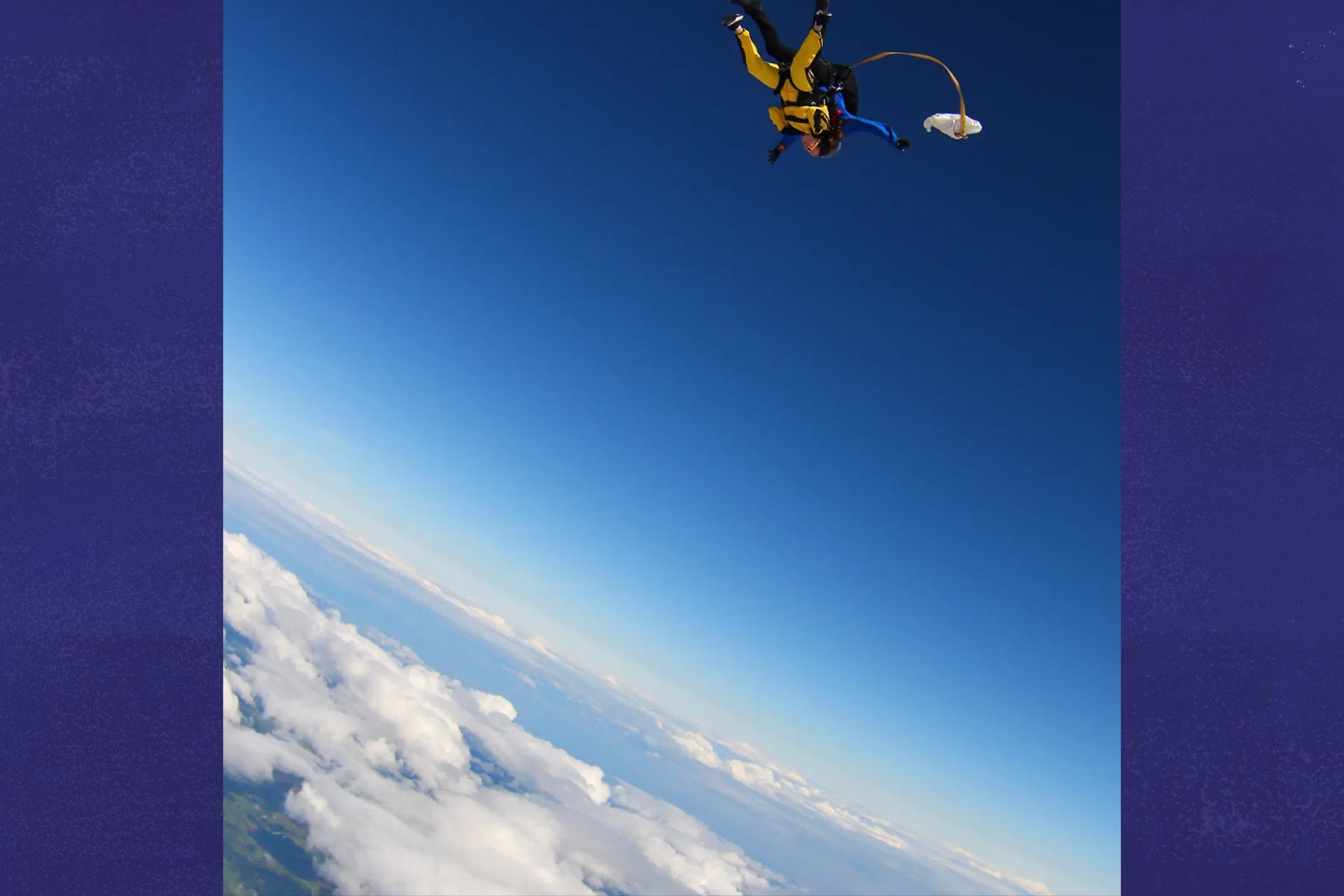 Our fundraiser Laura skydiving above the clouds.