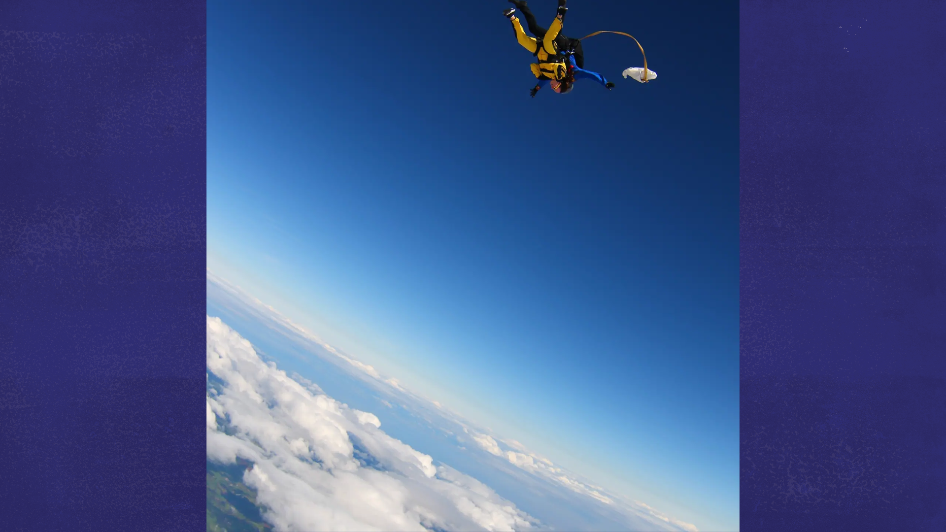 Our fundraiser Laura skydiving above the clouds.