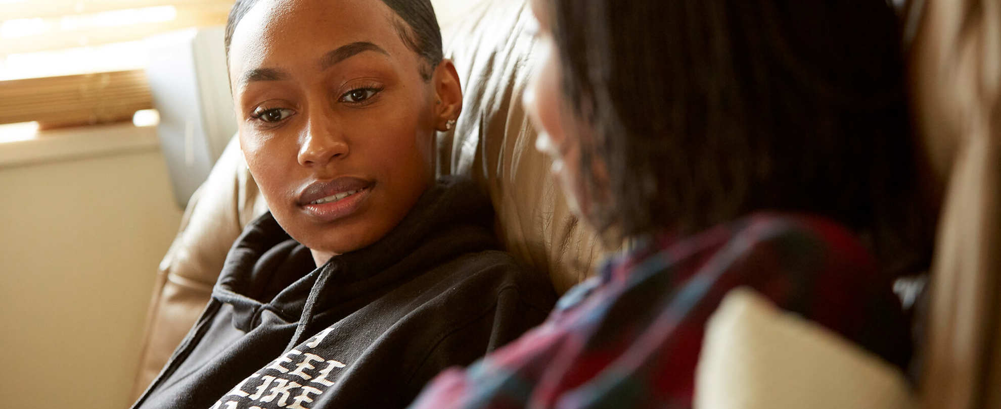 Mother and daughter having a serious talk on the sofa