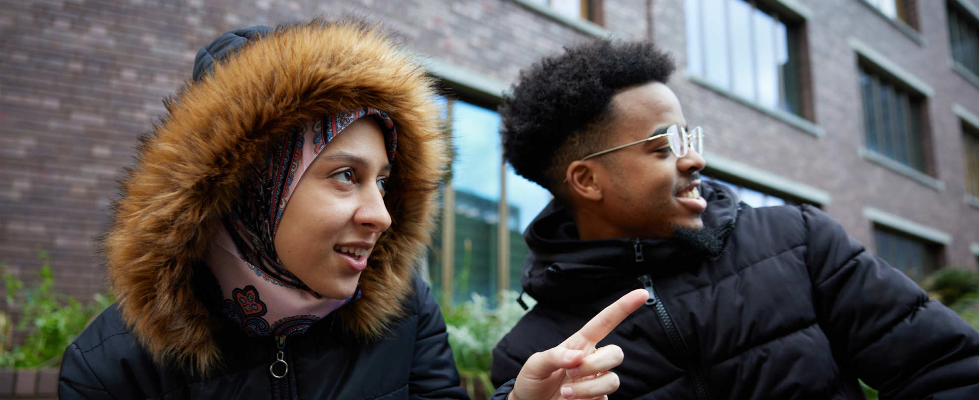 A person looking at what someone is pointing at.